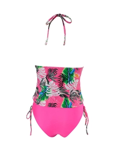 Back view of pink tankini set with tropical leaf print halter top and side-tie bikini bottoms
