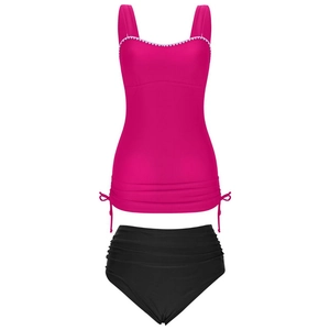 Detail of rose red tankini top with white zigzag lace trim and drawstring sides