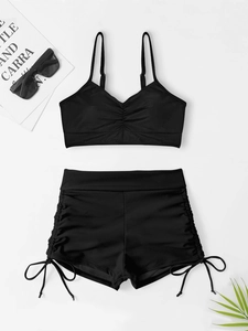 Flat lay of black two-piece bikini with ruched V-neck top and drawstring boy shorts
