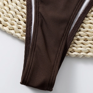 Detailed close-up of brown ribbed bikini bottoms featuring premium stitching and lining