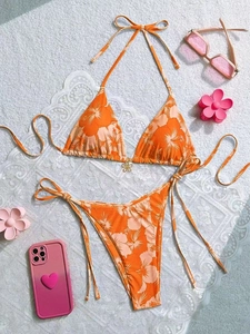 Orange tropical floral bikini set with metal flower pendant and side-tie bottom