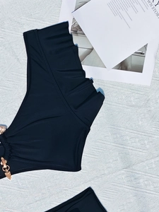 Sexy black bikini top with ruffled edges and gold chain featuring metal pendants