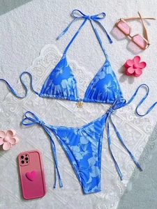 Blue hibiscus print two-piece string bikini set with gold floral charms on white lace