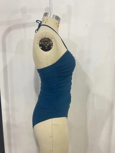 Side view of dark teal one-piece swimsuit with halter neck and side drawstring ruching