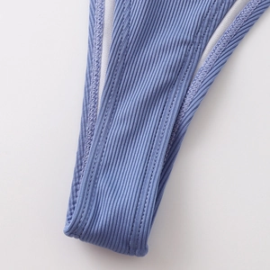 Detail of light lavender ribbed bikini fabric with seamless stitching and elastic texture