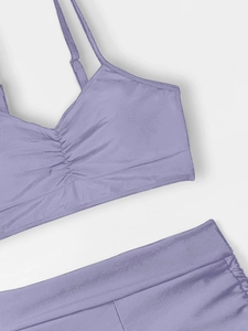 Detail of lavender v-neck bikini top with ruched texture and slim shoulder straps