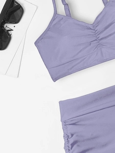 Flat lay of lavender purple two-piece bikini with ruched texture and adjustable drawstring