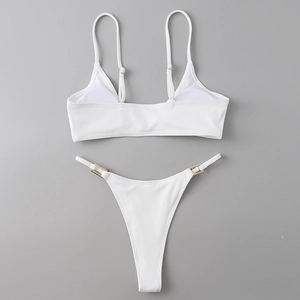 Detail of white ribbed bikini set showing gold metal buckles and fine knit texture