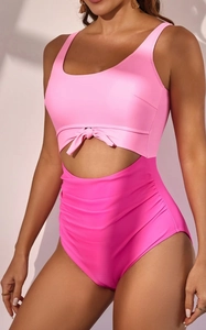 Detail view of pink and fuchsia high-waisted cutout swimsuit with front knot and side ruched texture