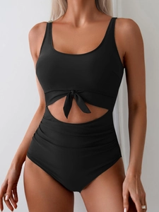 Front detail of black one-piece swimsuit with cutout waist and decorative bow knot