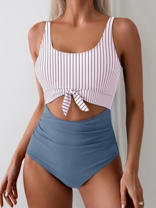 Detail of high waisted blue ruched bikini bottom and striped front knot top