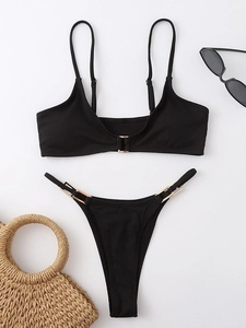 Black two-piece ribbed bikini set with gold metal buckles and high cut swim bottom