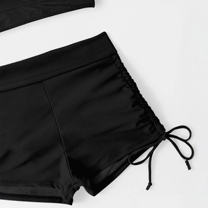 Women's black high-waisted bikini bottoms with adjustable side drawstring ruching details