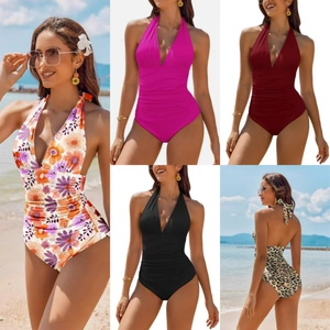 Detail of deep V-neck one-piece swimsuit with tummy control pleats and halter neck design