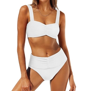 Detailed close-up of white ribbed fabric and flattering pleated high-waisted bikini bottoms
