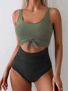 Close-up of olive green monokini with front knot detail and high-waisted black bottom