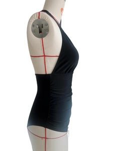 Detail view of black halter one-piece swimsuit with flattering waist ruching on mannequin