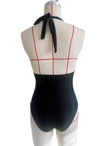 Rear view of black one-piece swimsuit featuring halter neck ties and backless design details