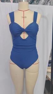 Detail view of royal blue one-piece swimsuit with front twist knot and teardrop cutout design