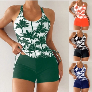 Detail view of two-piece swimwear set with palm tree print and side drawstrings