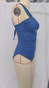 Detail view showing lateral ruching and pleated fabric of the royal blue swimsuit