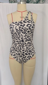 Detail of leopard print one-shoulder swimsuit featuring ruched side and textured fabric
