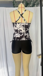 Detail view of two-piece swimsuit with coconut print top and criss-cross back straps