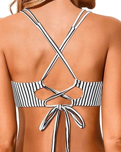 Detail of black and white striped bikini top featuring criss-cross back straps and tie bow