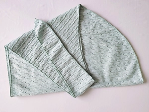 Detail of mint green bikini fabric with wavy pleats and uniform hollow mesh texture