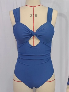 Blue one-piece swimsuit featuring front twist cutout and ruched bodice details