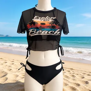 Detail of black mesh swim cover-up featuring sunset palm tree graphic and slogan