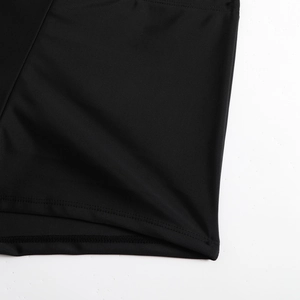 Close-up of double-needle stitching and fine knit texture on black modest swimwear