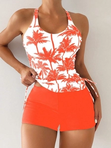 Detail of tropical palm print tankini top with side drawstrings and orange boy shorts