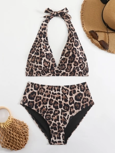 Flat lay detail of leopard print bikini set with stylish summer beach accessories