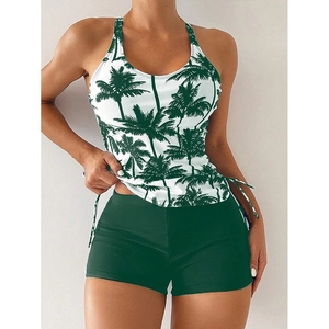 Detail of tropical palm print tankini top with adjustable side drawstring and green swim shorts