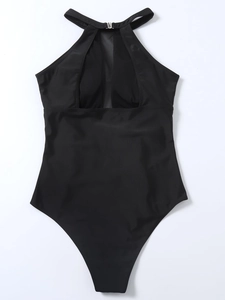 Detail of black halter one-piece swimsuit featuring mesh patchwork and pleated texture