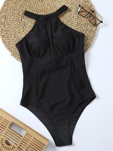 Detail view of black one-piece swimsuit featuring mesh panels and halter neck design
