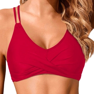 Detail of red bikini top featuring cross-front design and double spaghetti straps