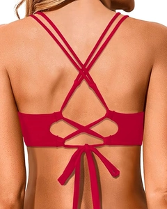 Detail of red bikini top featuring crisscross back straps and adjustable lace-up ties