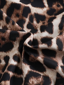 Close-up detail of leopard print swimsuit fabric with soft texture and rich draping