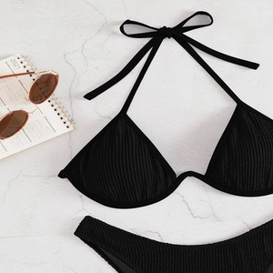 Detail of black halter bikini with textured fabric and metallic ring support