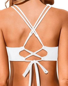 Detail of white bikini top featuring intricate multi-strap crisscross back design