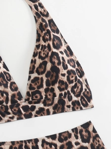Flat lay detail of leopard print bikini fabric with high waist cross design and smooth seams