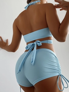 Detail of light blue two-piece bikini with cross-back tie and side drawstring boy shorts