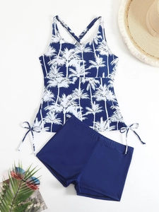 Sporty two-piece tankini set featuring navy coconut print top and boy-leg bottoms