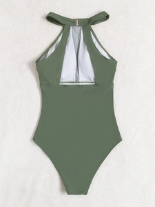 Detail of olive green one-piece swimsuit featuring mesh panels and metal neck buckle closure