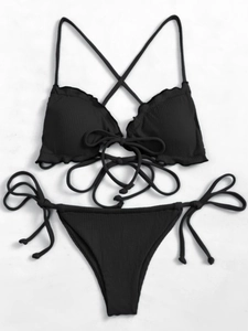 Flat lay of black ribbed bikini with ruffle trim and cross-strap tie detailing