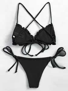 Close-up of black ribbed bikini fabric with tie-side detailing and soft texture