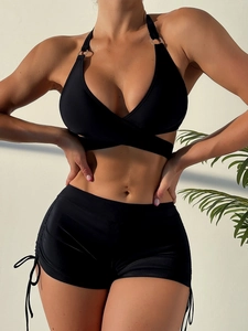 Detail of black halter bikini top with metal ring buckle and side drawstring shorts