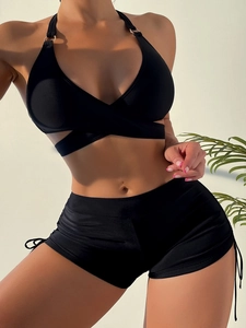 Detail of black halter bikini top with metal ring and drawstring boy shorts
